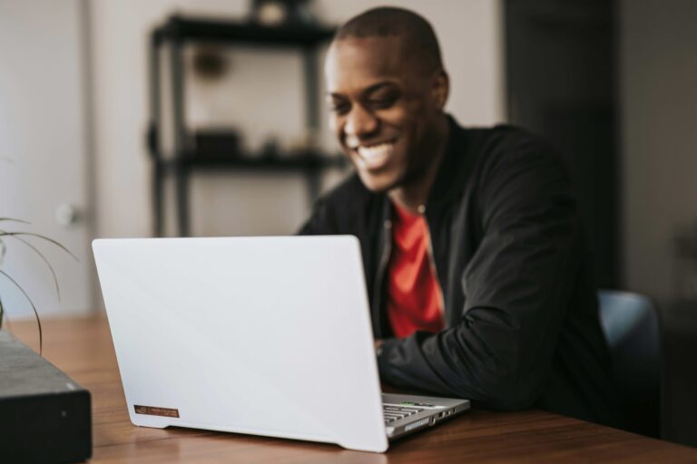 a guy enjoying his time at his laptop